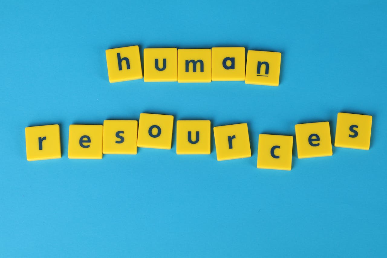 Yellow tiles spelling 'human resources' on a blue background, ideal for HR or business concepts.